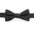 Close-up of a black silk bow tie featuring a repeating Mickey Mouse silhouette and diamond geometric pattern.
