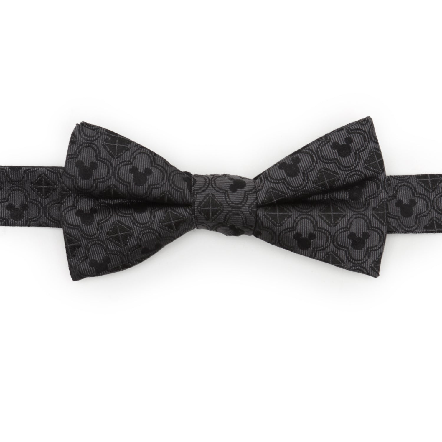 Close-up of a black silk bow tie featuring a repeating Mickey Mouse silhouette and diamond geometric pattern.