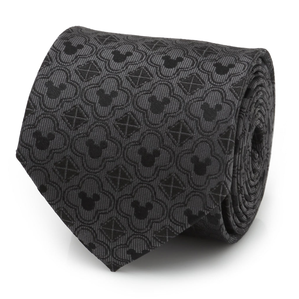 A black necktie featuring a repeating pattern of Mickey Mouse silhouettes, clover shapes, and geometric diamonds.