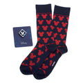 A gift set containing navy blue crew socks with a repeating red Mickey Mouse pattern and a small silver and blue Mickey Mouse enamel lapel pin.
