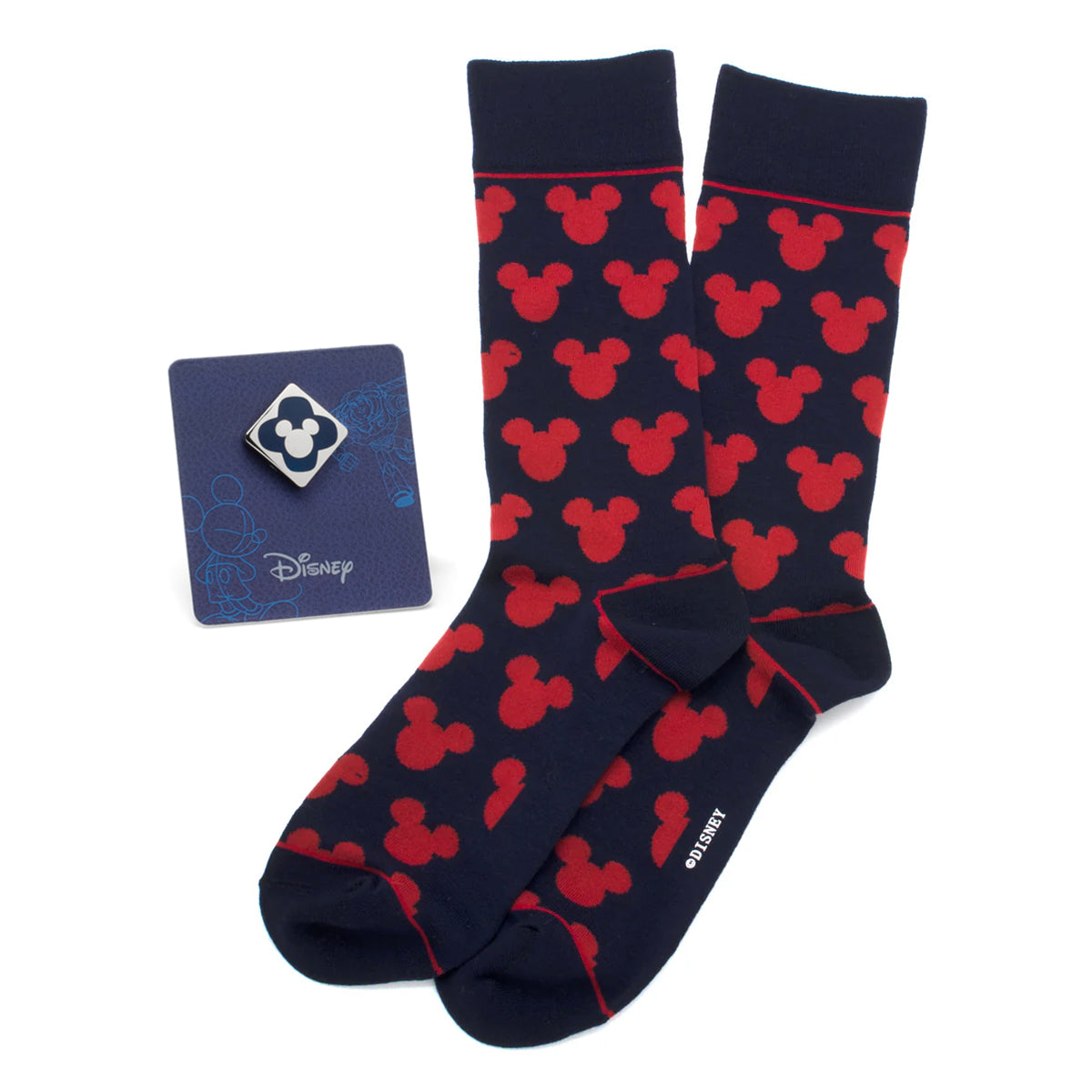 A gift set containing navy blue crew socks with a repeating red Mickey Mouse pattern and a small silver and blue Mickey Mouse enamel lapel pin.