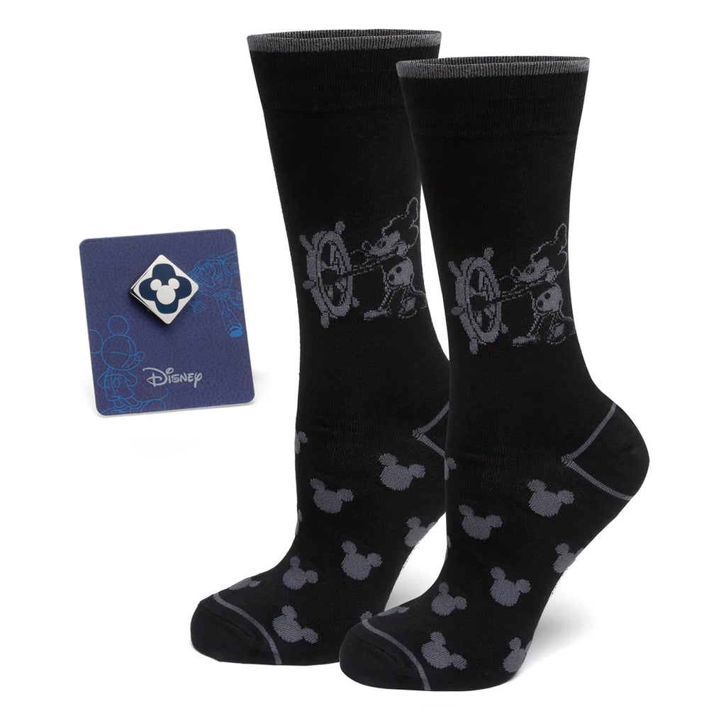 A pair of black socks featuring a Steamboat Willie graphic and a matching blue Mickey Mouse enamel lapel pin.