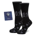 A pair of black socks featuring a Steamboat Willie graphic and a matching blue Mickey Mouse enamel lapel pin.