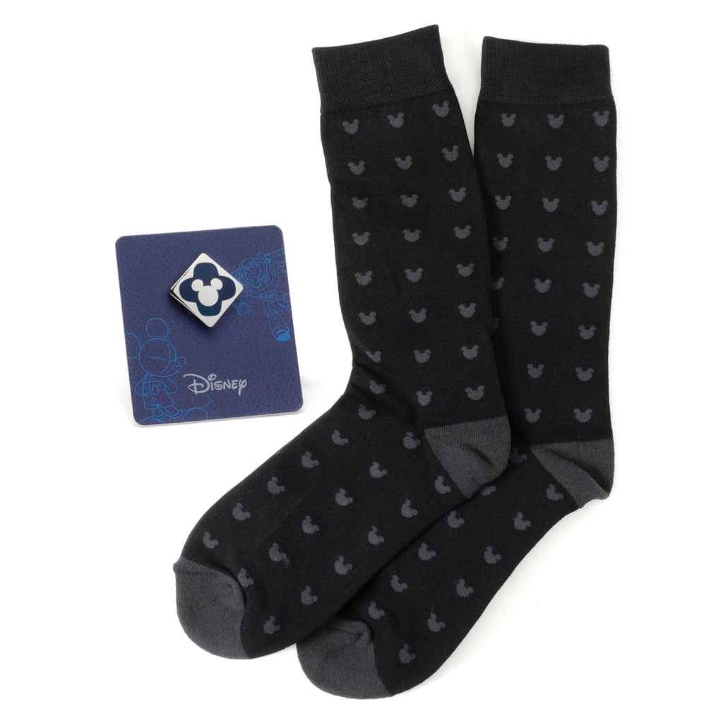 A gift set featuring black socks with a Mickey Mouse pattern and a blue Mickey Mouse enamel lapel pin.
