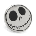 Close up of a circular Jack Skellington lapel pin featuring a black and silver face with a secure metal clutch backing.