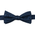 Close up of a navy blue silk bow tie featuring a subtle paisley print with Mickey Mouse head silhouettes.