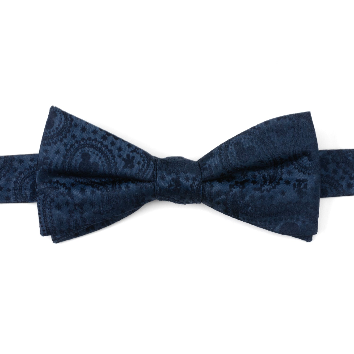 Close up of a navy blue silk bow tie featuring a subtle paisley print with Mickey Mouse head silhouettes.