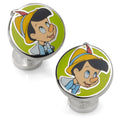 A pair of round Disney Pinocchio enamel cufflinks with a silver-tone finish and an apple design on the back