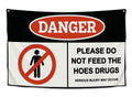 Edgy wall flag with hazard sign design reading Do Not Feed the Hoes in red, black, and white