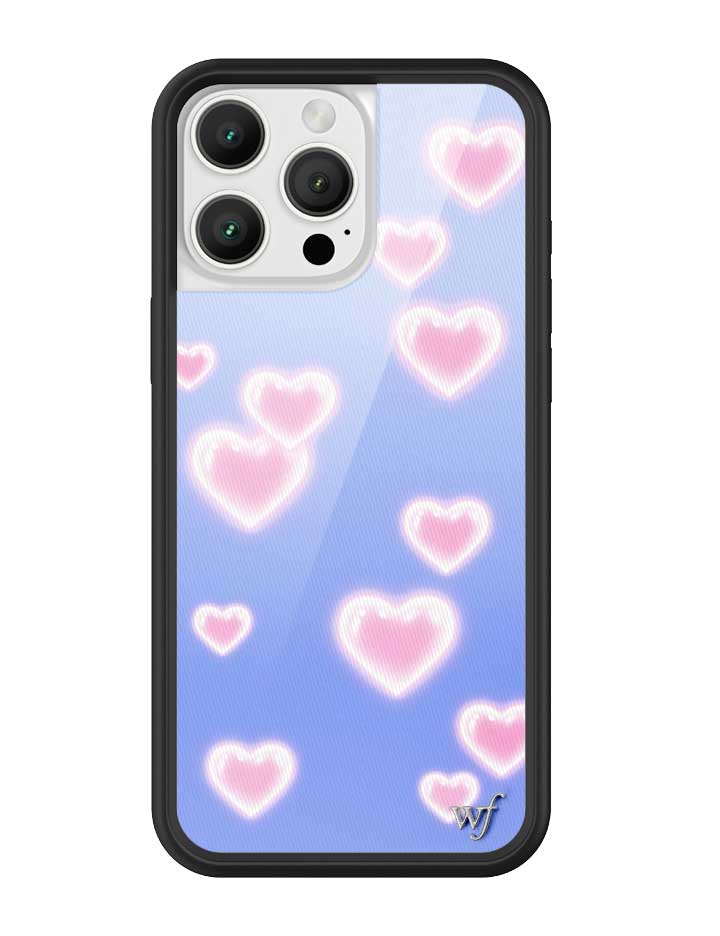 iPhone case featuring a soft blue background with glowing pink heart patterns and a black rubber bumper.