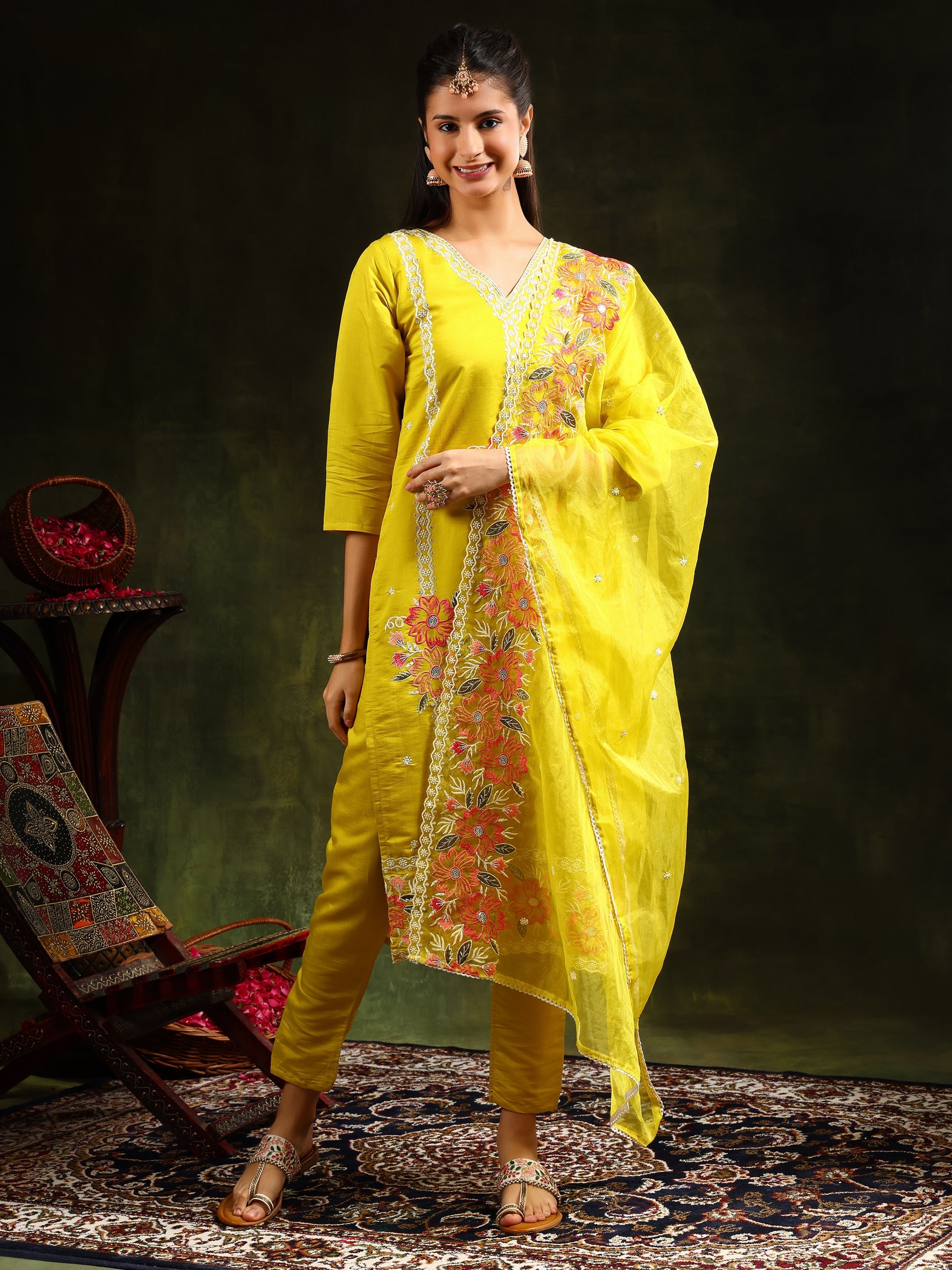 Woman wearing a vibrant yellow Chanderi kurta set with intricate embroidery, matching pants, and a dupatta.