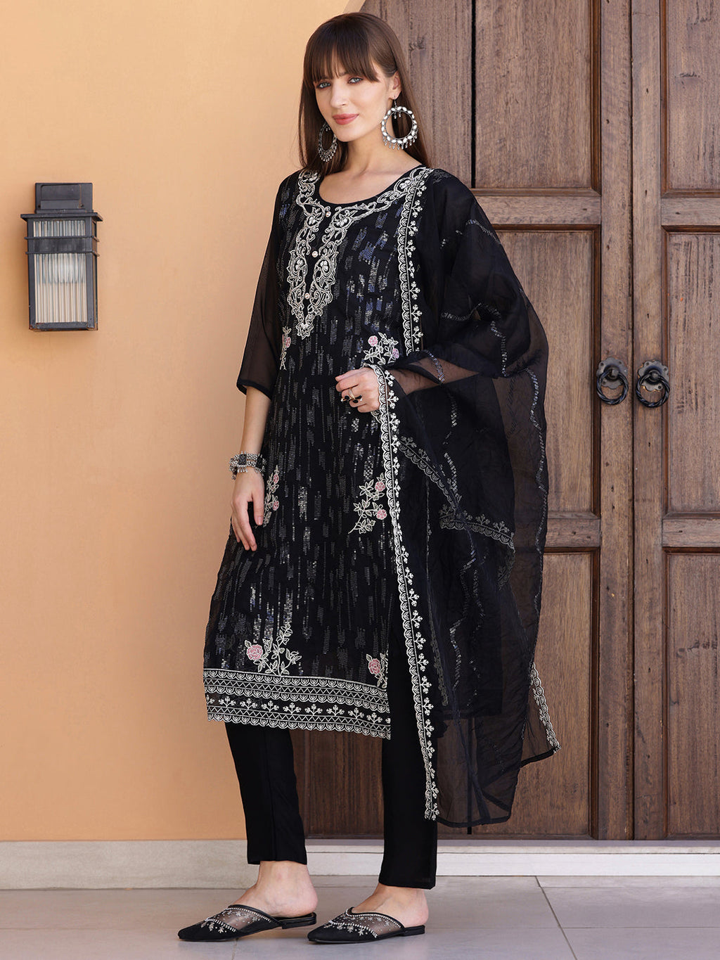 Elegant black Pakistani-style kurta set with intricate sequined embroidery and matching dupatta