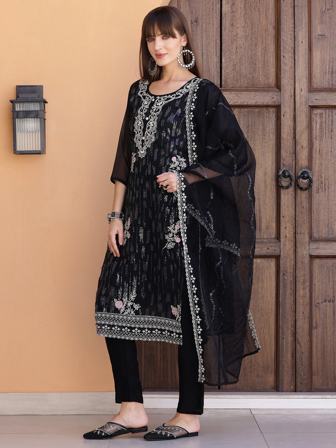 Elegant black Pakistani-style kurta set with intricate sequined embroidery and matching dupatta