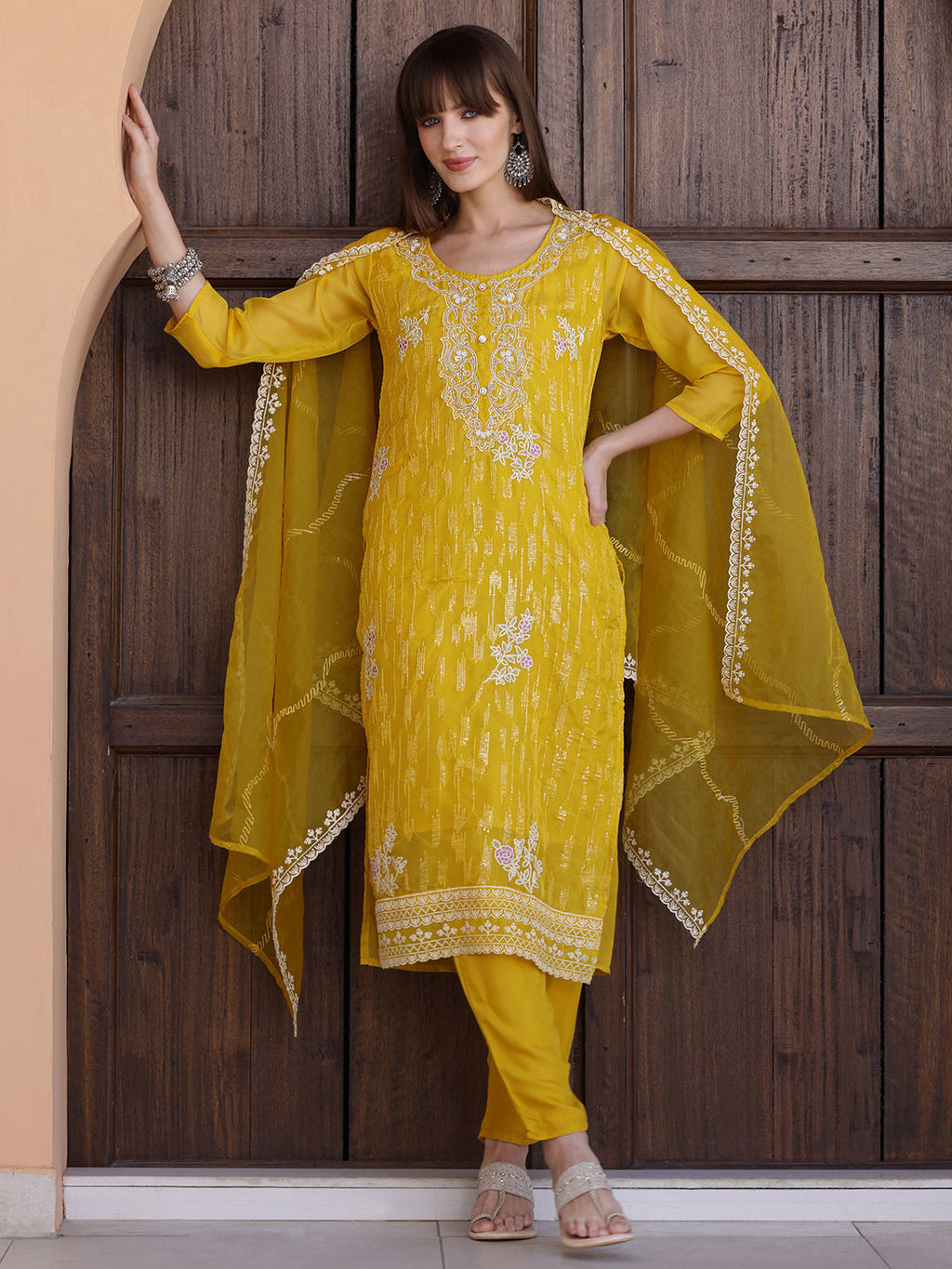 Elegant yellow Pakistani style kurta with sequin embroidery, matching pants, and dupatta.