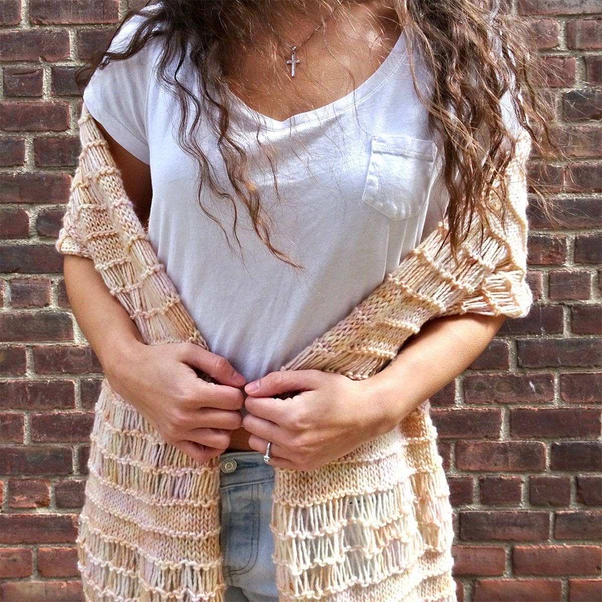 Hand-knitted Spring Vibes shawl with airy stitches and bohemian fringe detailing