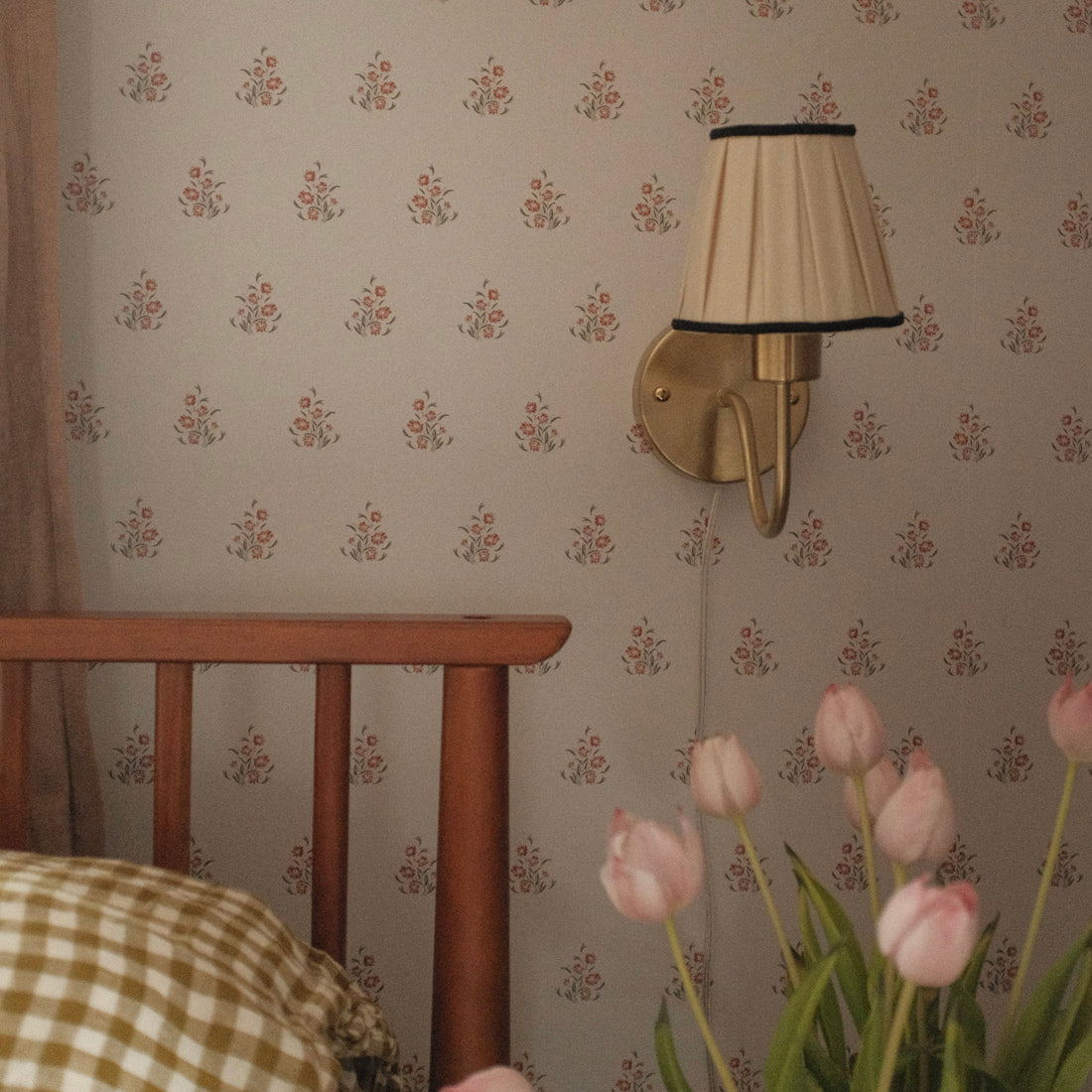 Vintage-inspired floral wallpaper featuring blue and brown motifs on a soft neutral background in a traditional living room