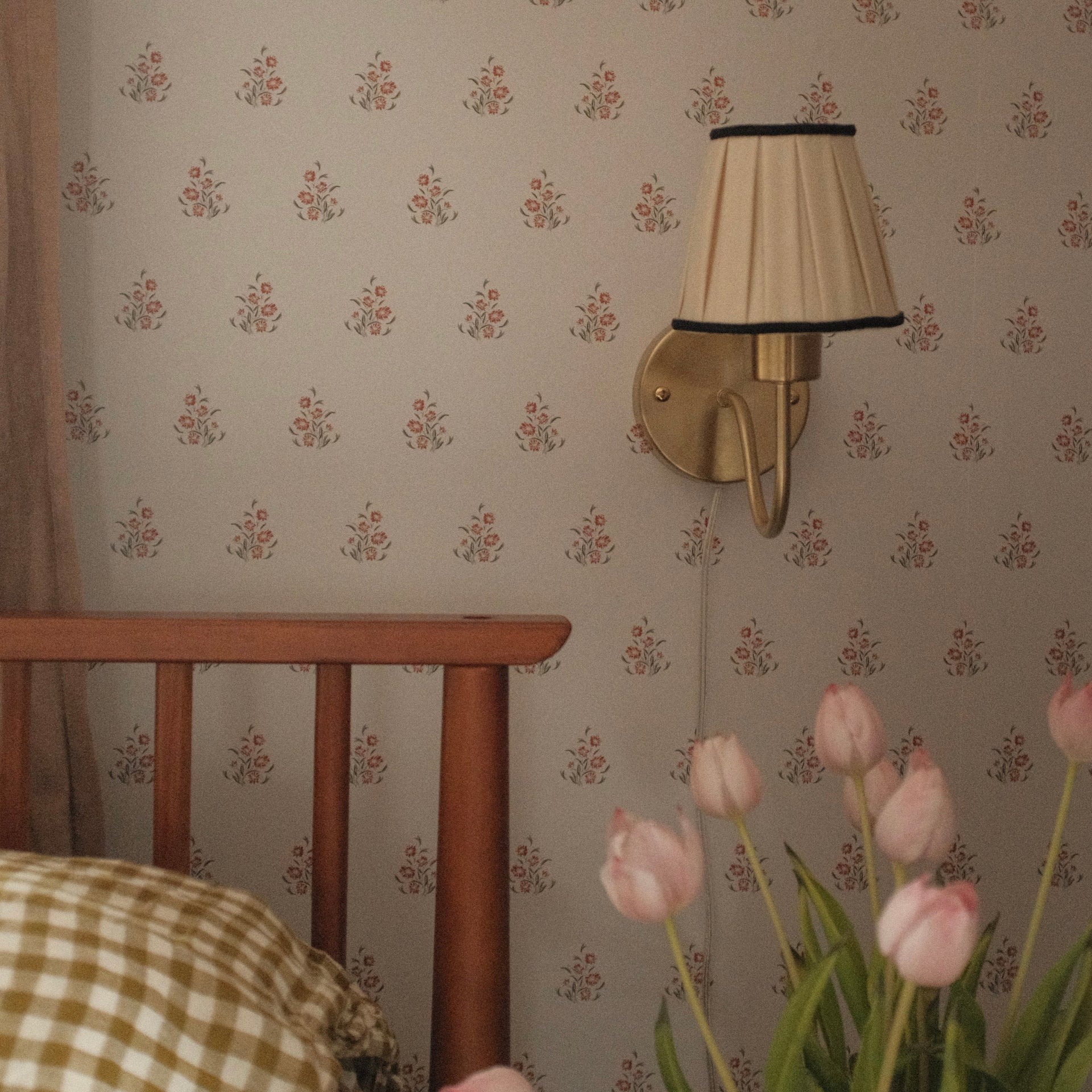 Vintage-inspired floral wallpaper featuring blue and brown motifs on a soft neutral background in a traditional living room