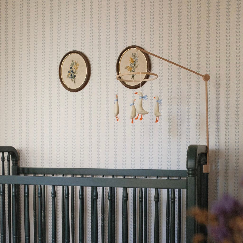 Close up of Francesca geometric wallpaper in sage-green and beige tones with a cottagecore traditional pattern.