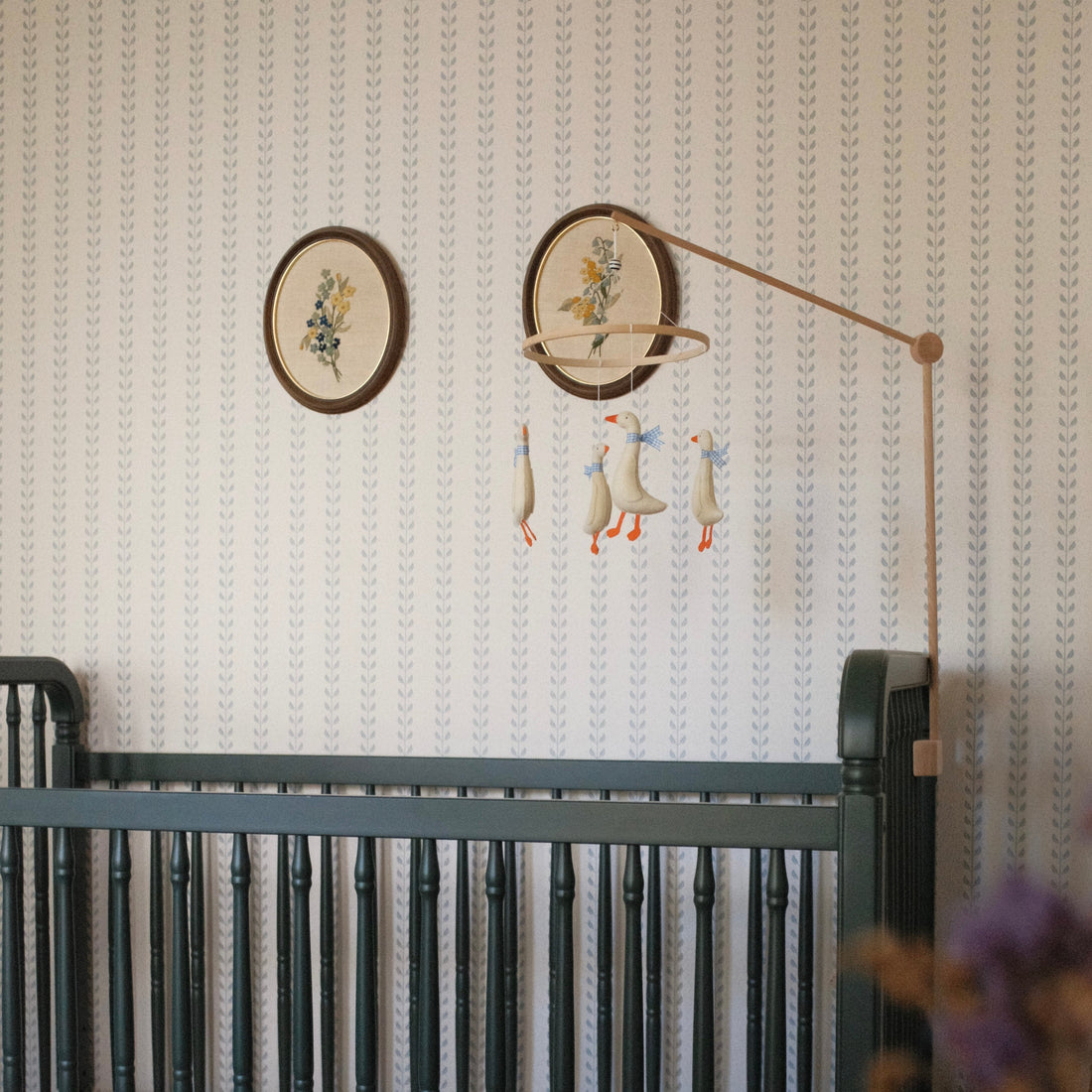 Close up of Francesca geometric wallpaper in sage-green and beige tones with a cottagecore traditional pattern.