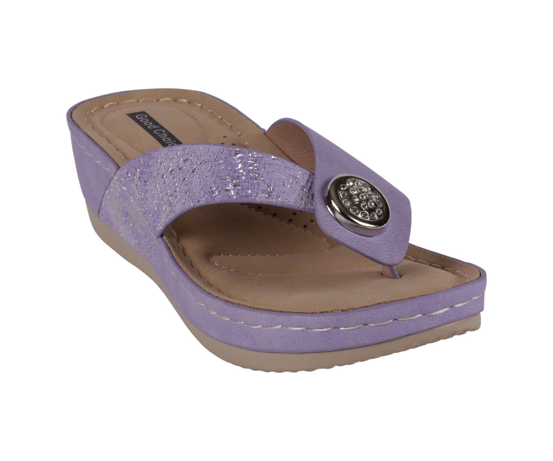 A pair of lilac wedge sandals featuring metallic textured straps and a decorative silver emblem on the thong.