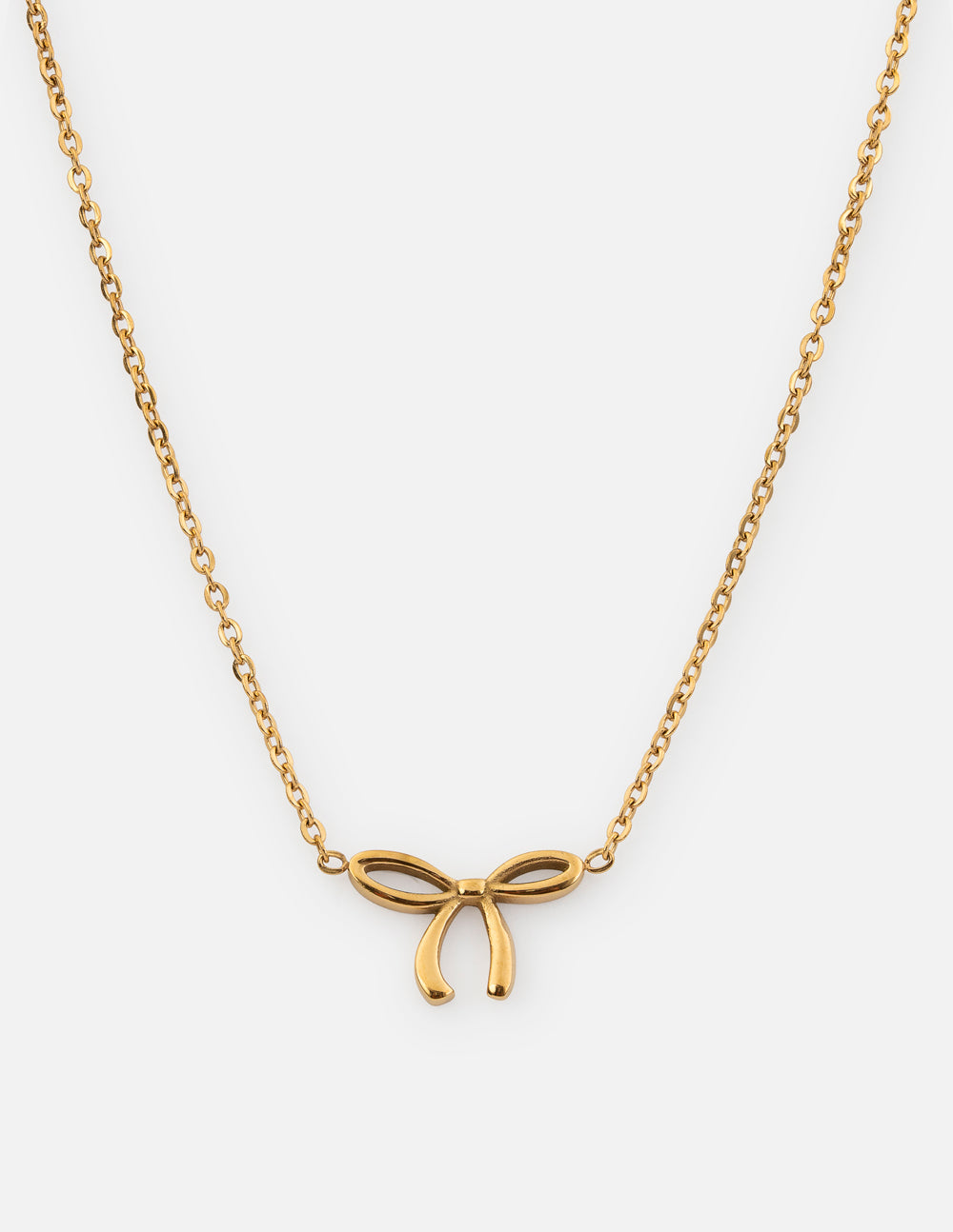 Dainty gold bow necklace with a minimalist ribbon pendant on a delicate cable chain