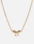 Dainty gold bow necklace with a minimalist ribbon pendant on a delicate cable chain