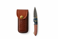 Titan Patriot Damascus folding knife with red, white, and blue handle and patterned steel blade.