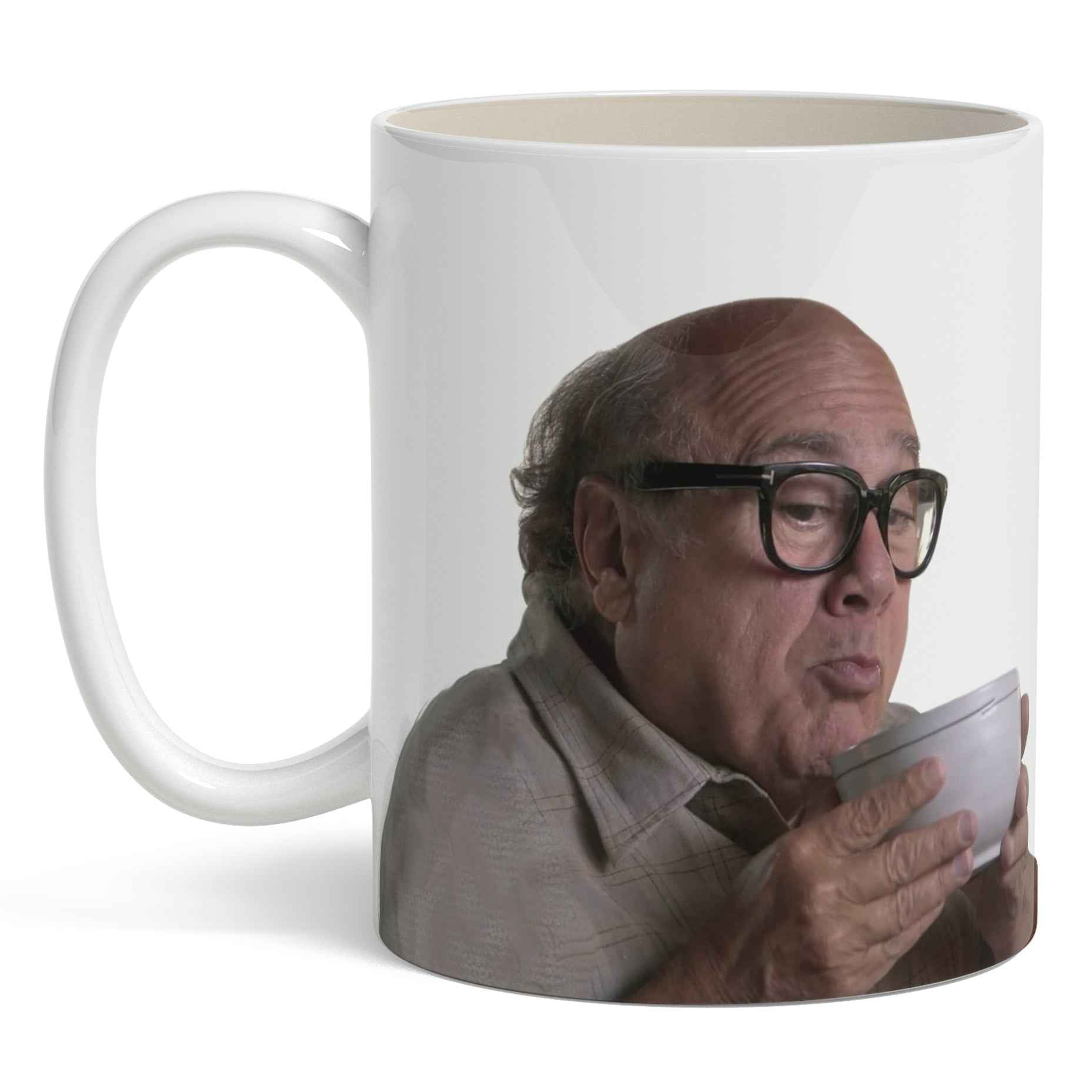 A high-contrast ceramic coffee mug featuring a portrait of Danny DeVito against a neutral background.