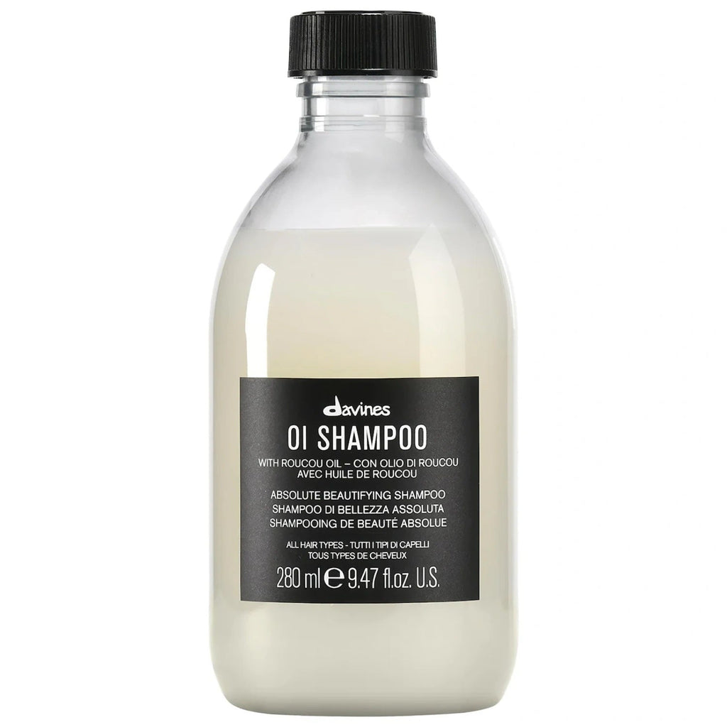 Davines OI Shampoo bottle with transparent design, off-white contents, and black label.