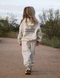 Child wearing an oversized, cozy Deeply Loved hoodie, perfect for layering and comfort.