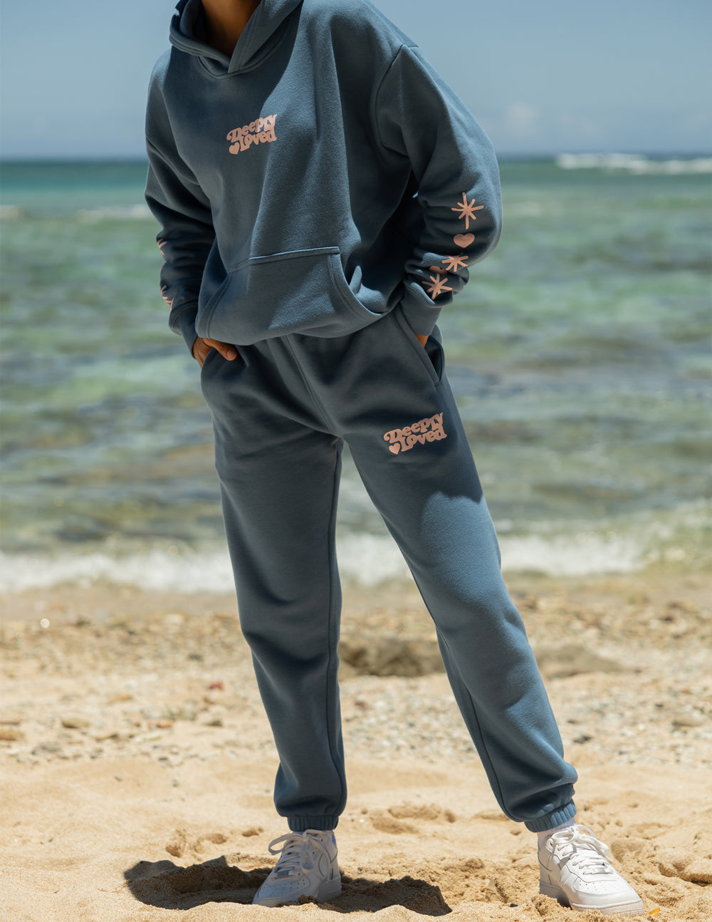 Unisex knit sweatpants in blue and pink with Deeply Loved embroidery detail