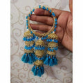 Dista blue silk thread and pearl bangle with gold-tone hanging jhumka charms.