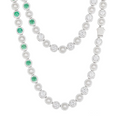 Sterling silver necklace with alternating white pearls and round green gemstones, featuring sparkling clear stone halos, worn by a model and shown on a white background.