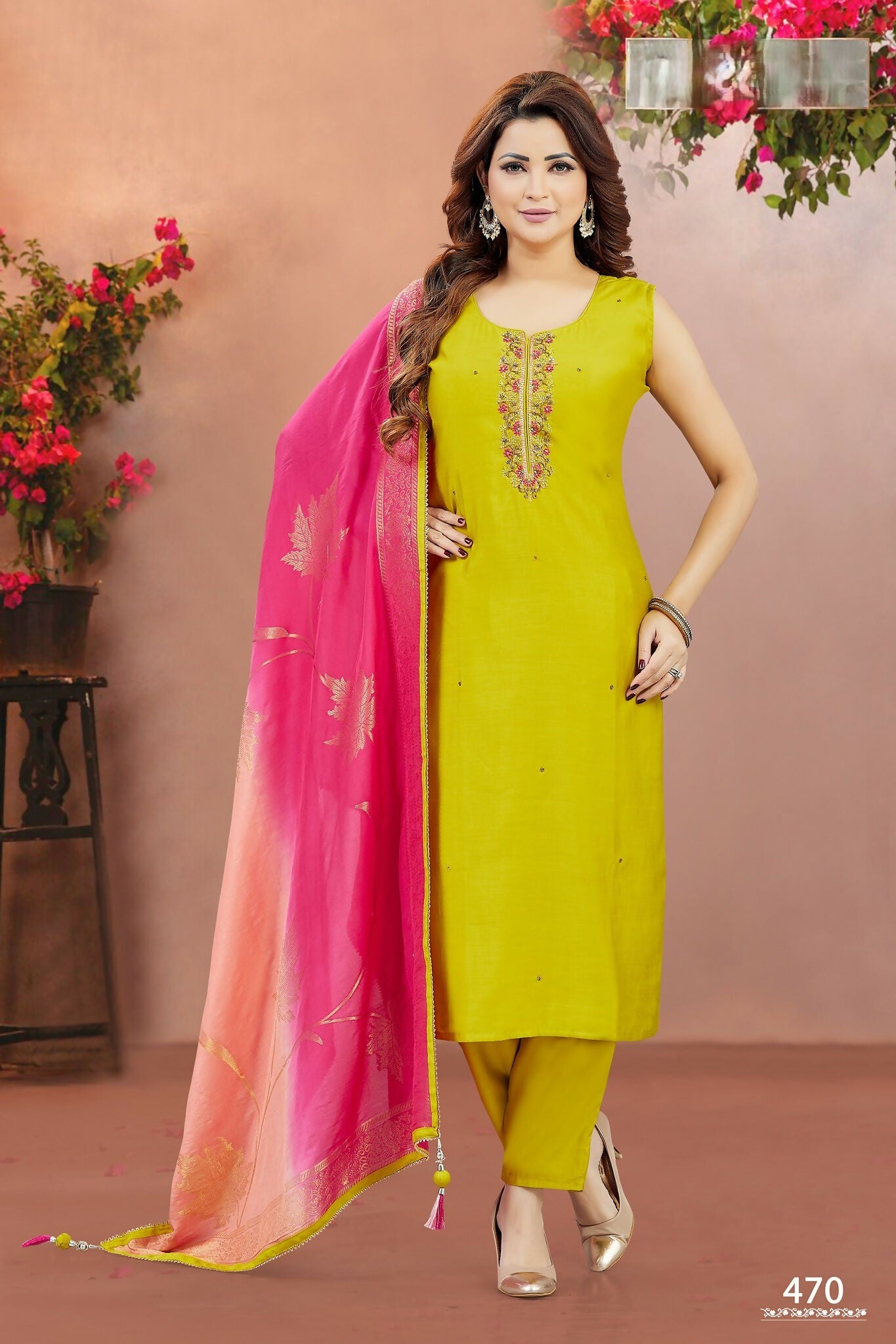 Woman wearing a vibrant yellow soft silk embroidered kurta set with matching dupatta