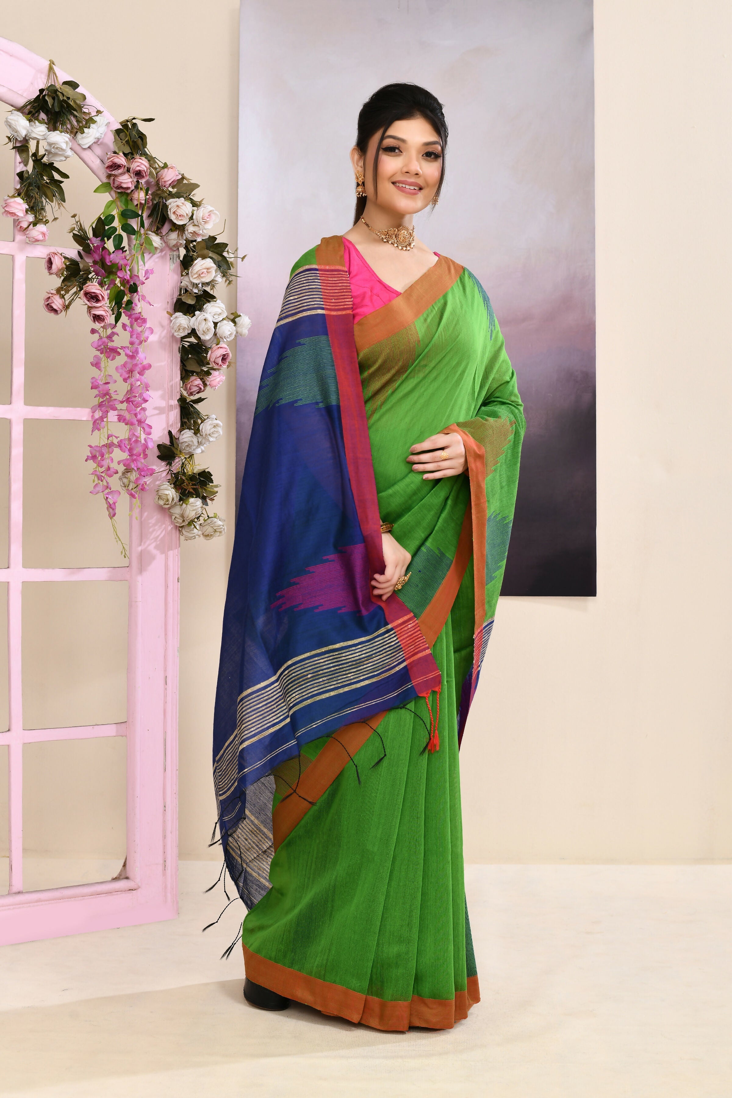 Vibrant Green Jamdani Saree with traditional temple border and intricate embellishments.