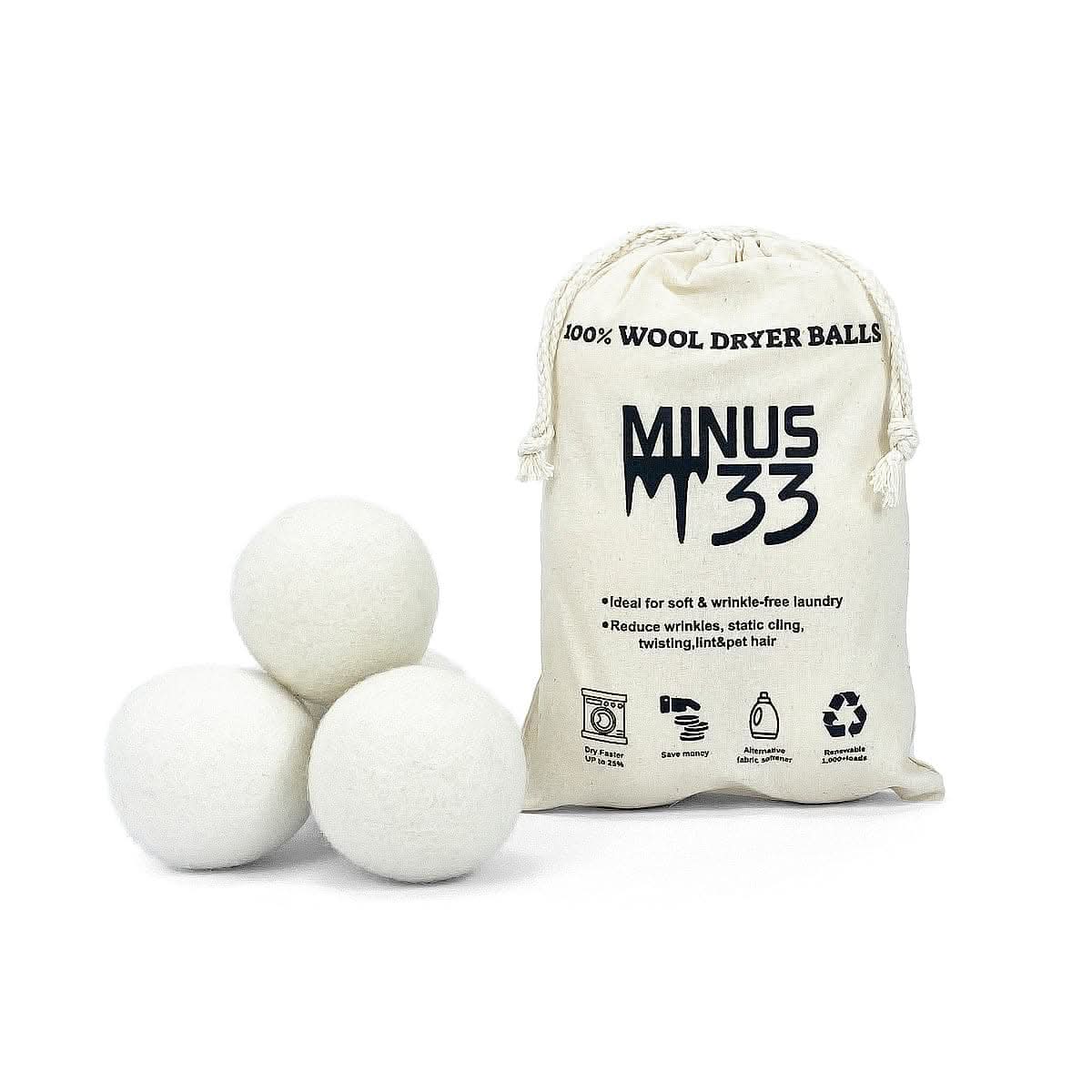 Set of 6 white wool dryer balls in a canvas bag on a laundry room surface