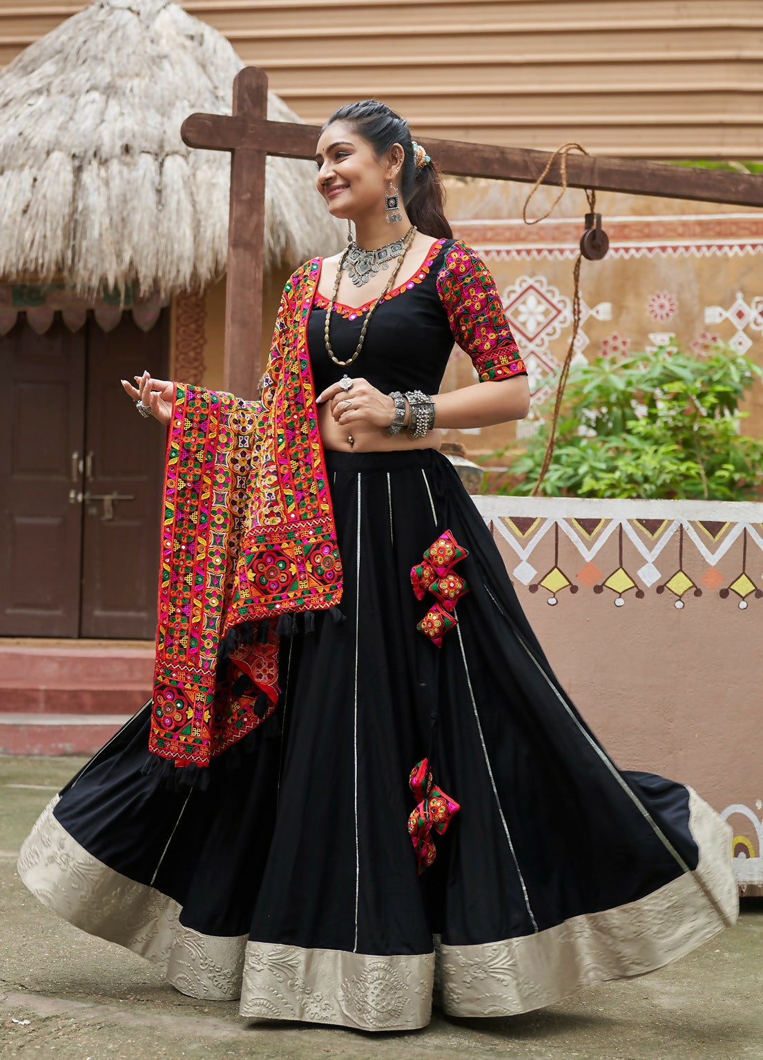 Black viscose rayon lehenga choli with a red dupatta for Navratri festive wear