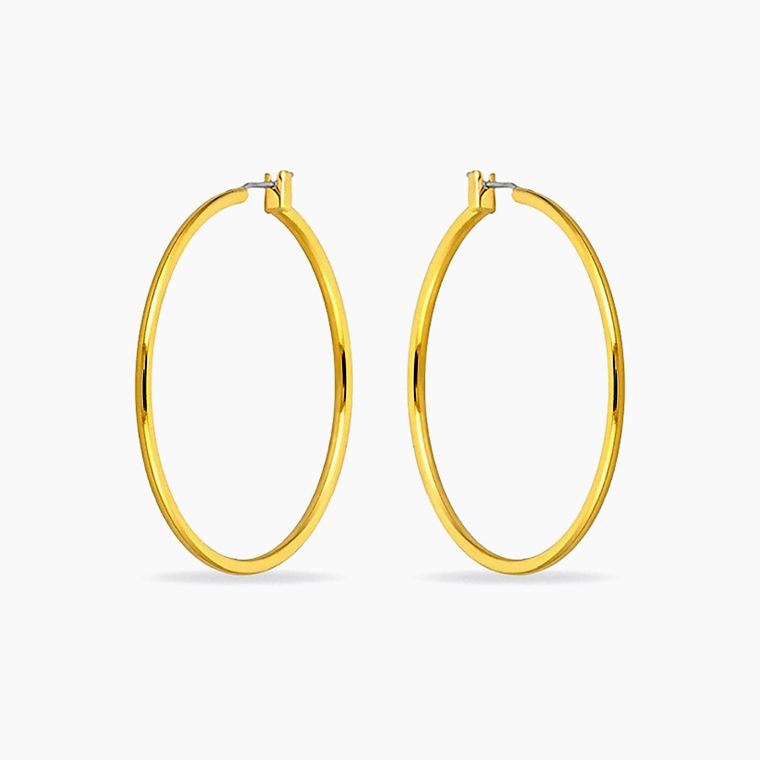 A pair of large high-polished gold-plated hoop earrings against a white background.