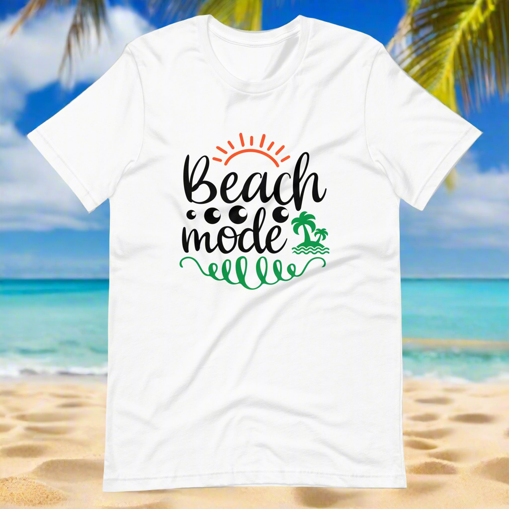 White graphic t-shirt with Beach Mode text and palm tree design on a beach background.