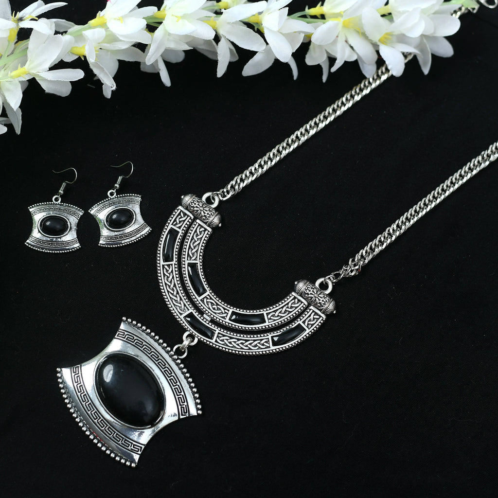 Close-up of a handcrafted oxidised silver-plated long necklace with stone work detailing.