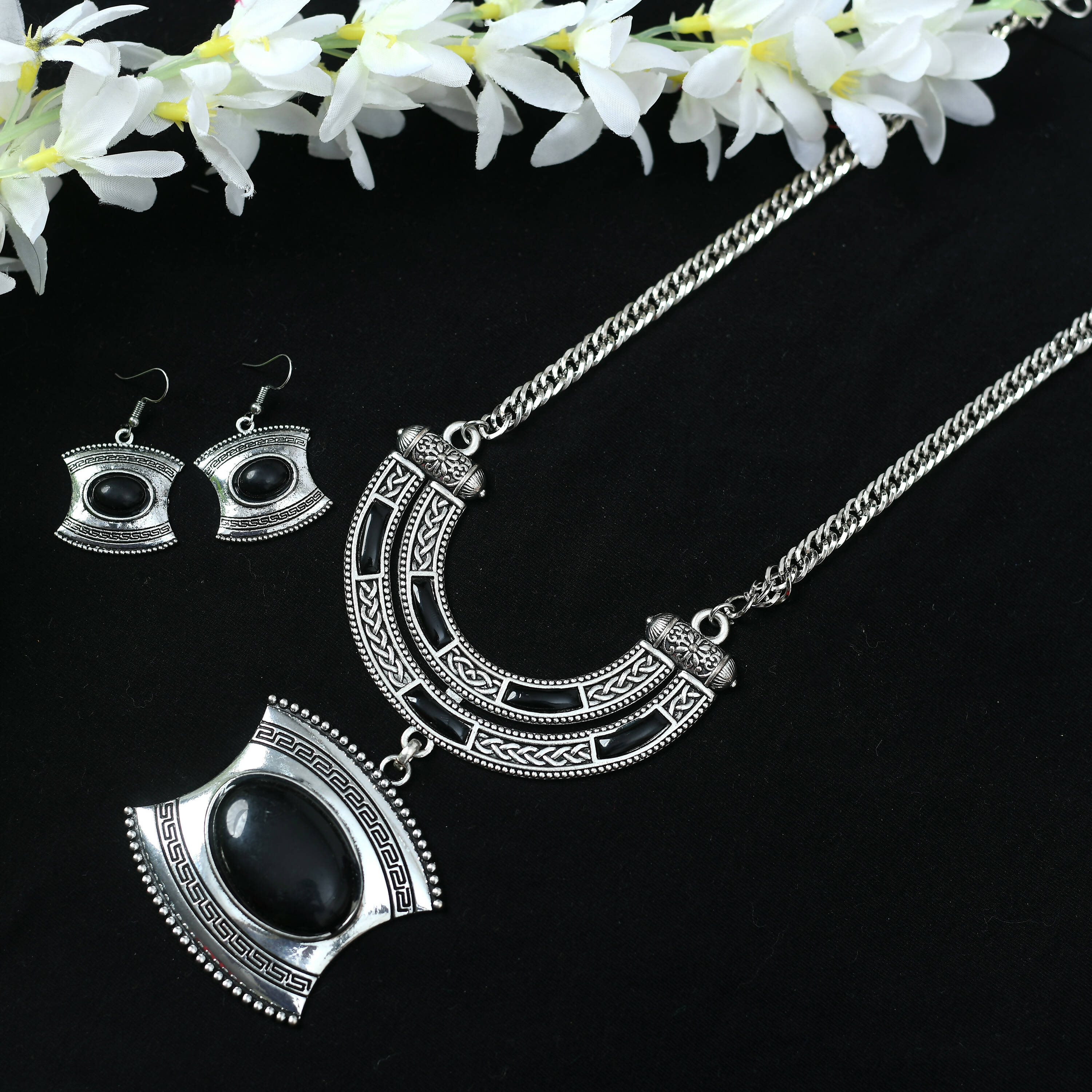 Close-up of a handcrafted oxidised silver-plated long necklace with stone work detailing.