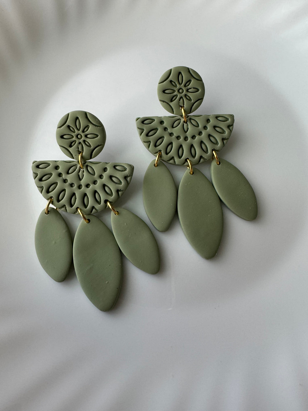 Willow earrings in spring green polymer clay with gold-tone hardware on a white background