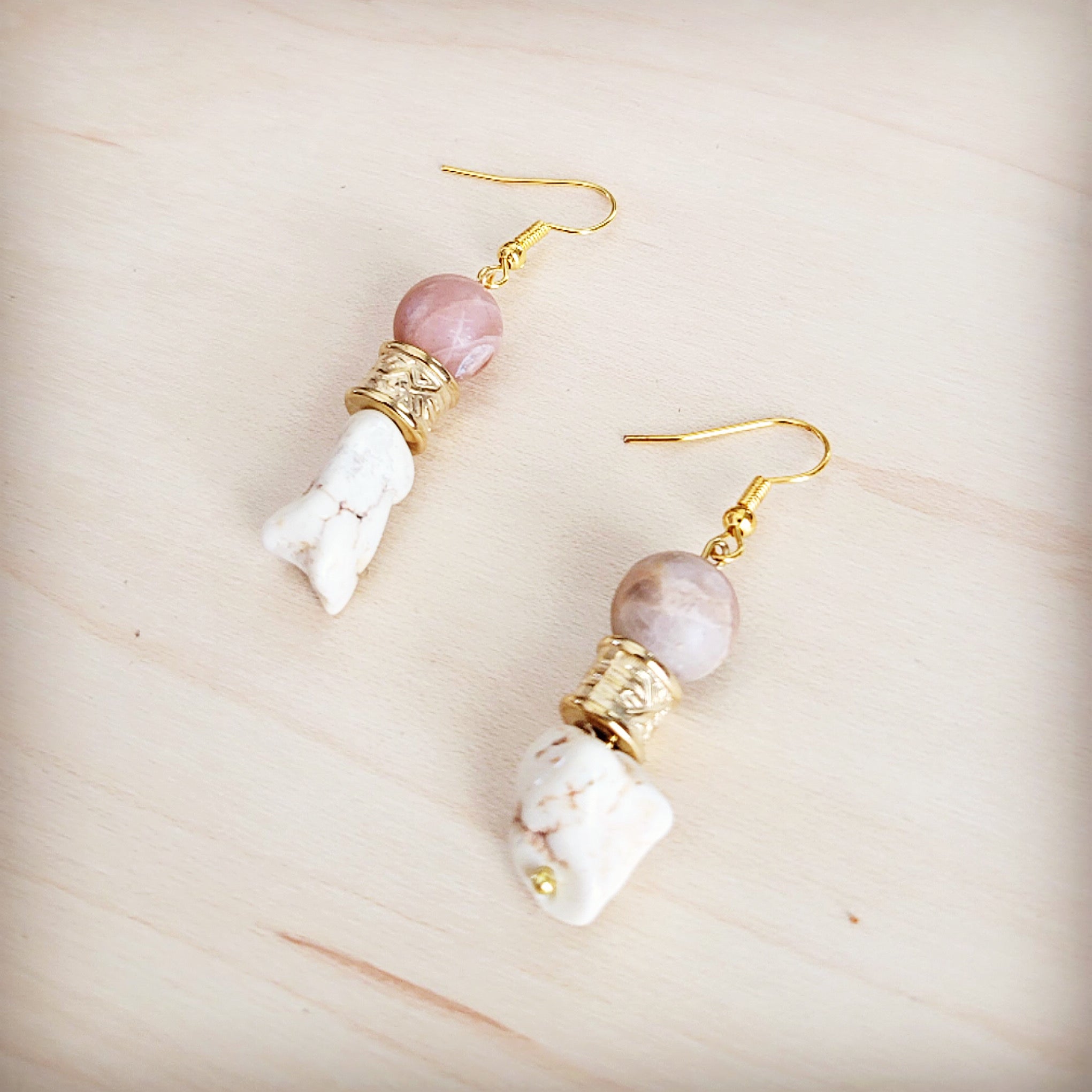 A pair of gold-tone drop earrings featuring frosted sunstone beads and rough white turquoise stones.