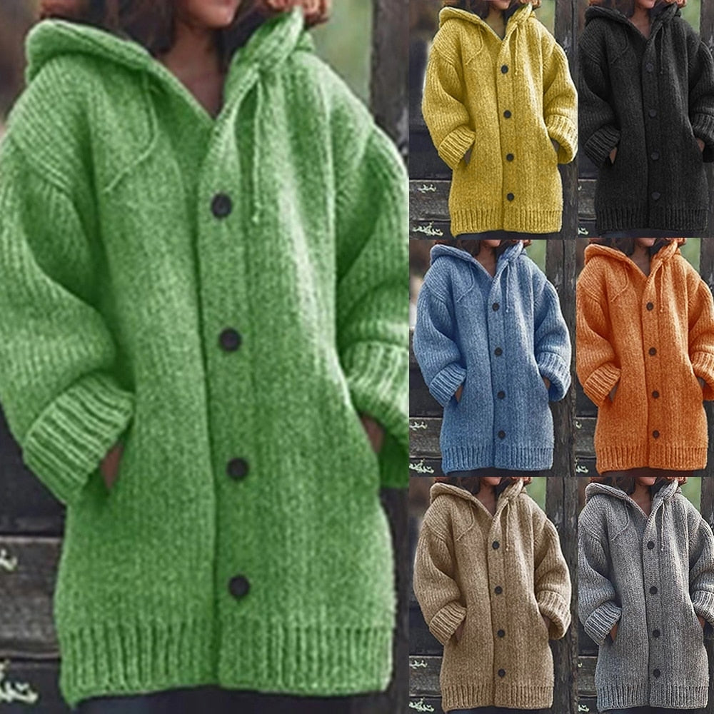 A woman wearing a grey hooded knitted button-up cardigan with ribbed details and front pockets.