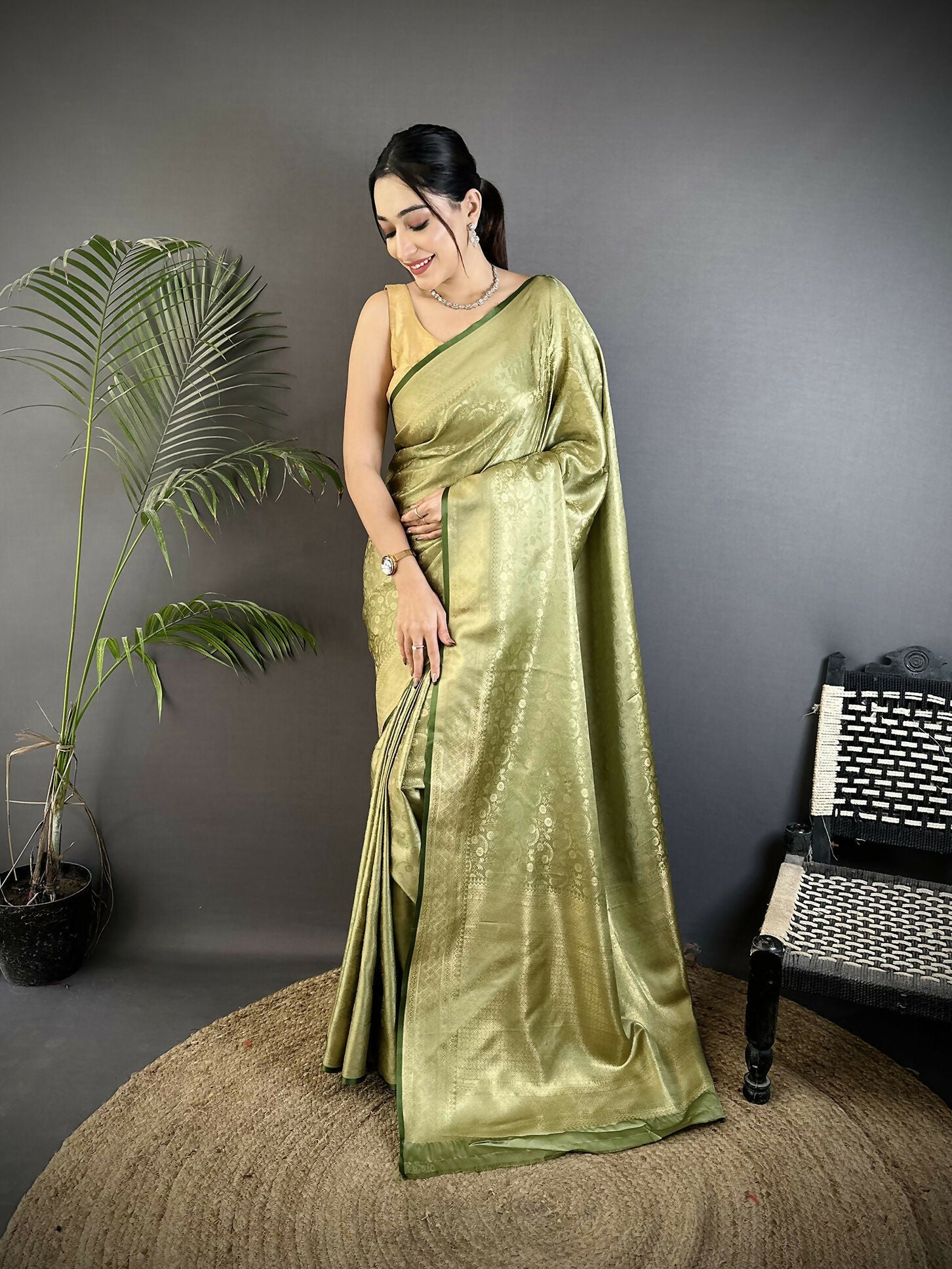 Elegant Olive Green Satin Silk Banarasi Saree with floral and paisley motifs and matching blouse piece