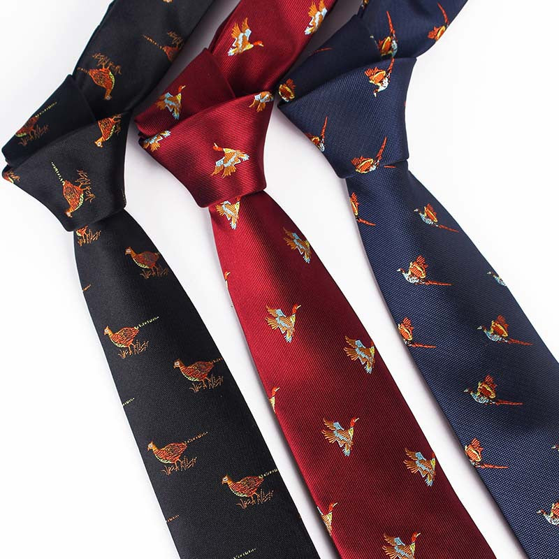 Three yarn-dyed jacquard neckties with colorful bird patterns in red, navy, and black, displayed against a white background.