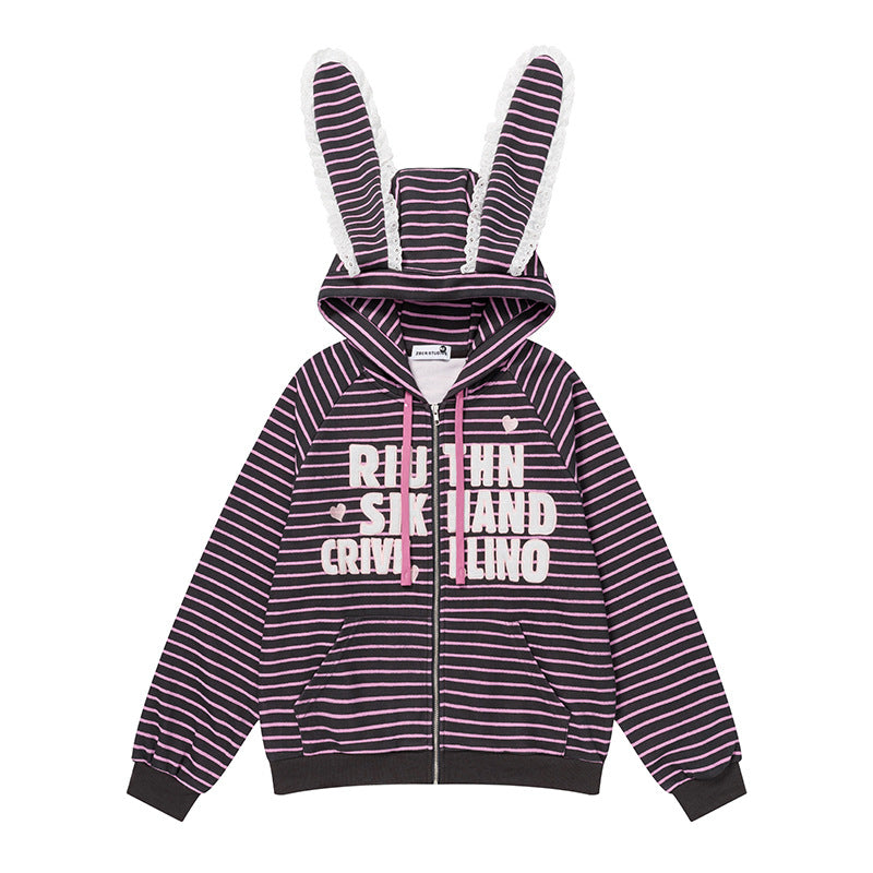 Front view of a women's black and pink striped full-zip hoodie with white lace-trimmed bunny ears on the hood and graphic text on the chest.