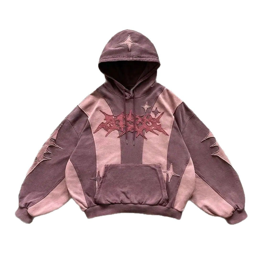 Y2K grunge style oversized hoodie with patchwork design, star details, and a front kangaroo pocket, shown in two colorways: mauve/pink and black/cream.