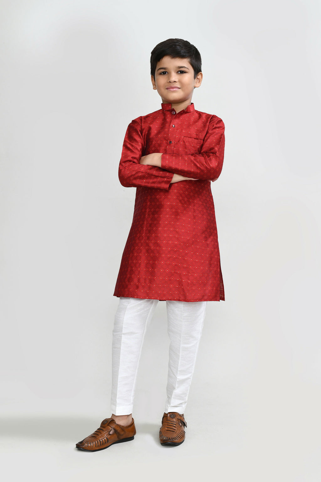 A rich red Jacquard silk kurta set with white straight-fit trousers