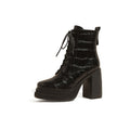 Women's black and white croc-embossed leather lace-up short boots with thick platform soles and chunky heels.